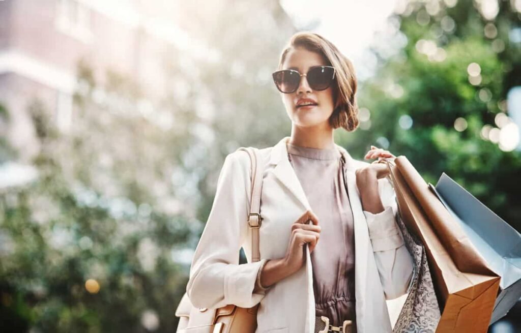 A 6.2% Dividend Stock Paying $50 Every Month shopper carries paper bags with purchases